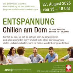 Junge Menschen sitzen im Kreis auf einer Wiese